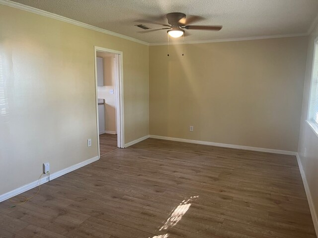 unfurnished room featuring crown molding, dark wood-style flooring, a ceiling fan, and a textured ceiling