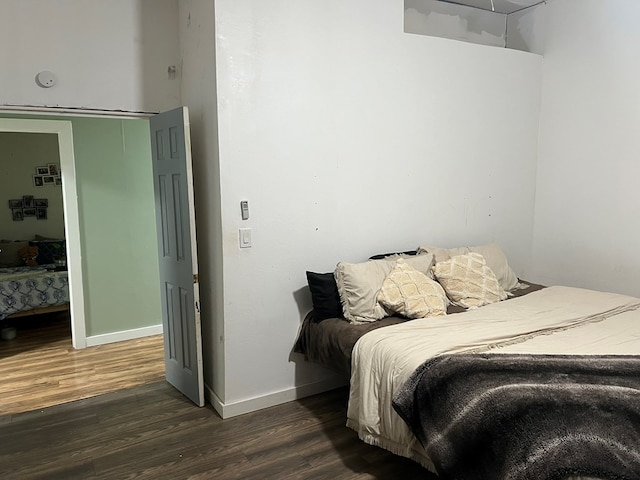 bedroom featuring baseboards and wood finished floors