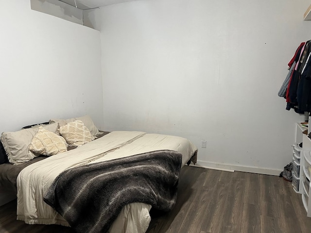 bedroom with baseboards and wood finished floors