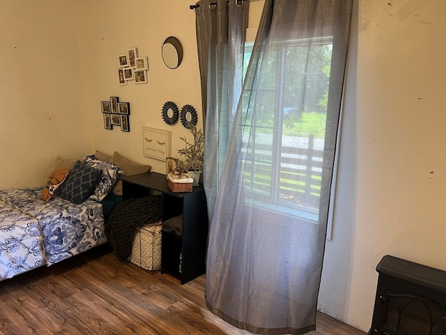 bedroom featuring wood finished floors and multiple windows