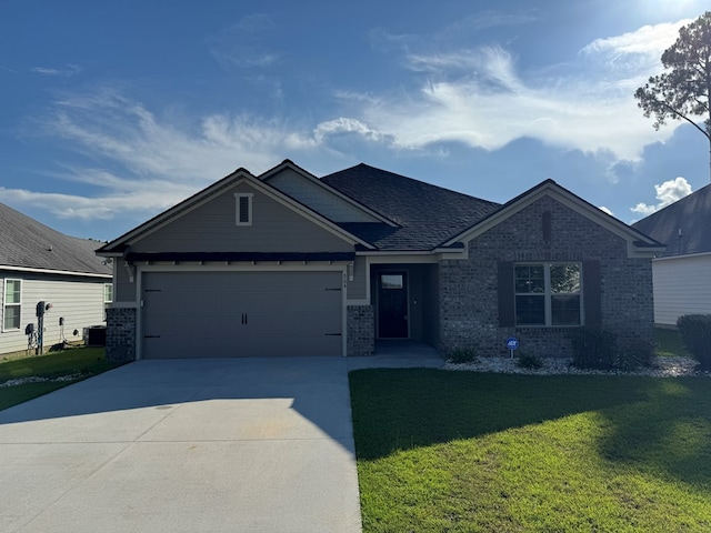 564 Osprey Cir, Tifton, GA 31794 - view of front of home with driveway, brick siding, a front lawn, a garage, and roof with shingles
