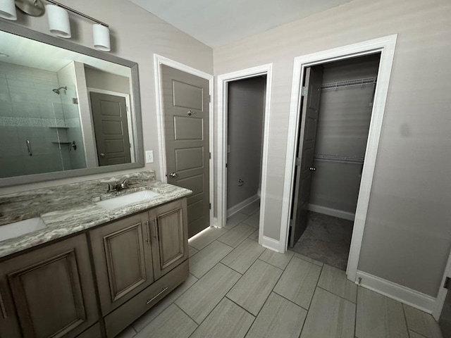 564 Osprey Cir, Tifton, GA 31794 - bathroom with a stall shower, double vanity, and a walk in closet