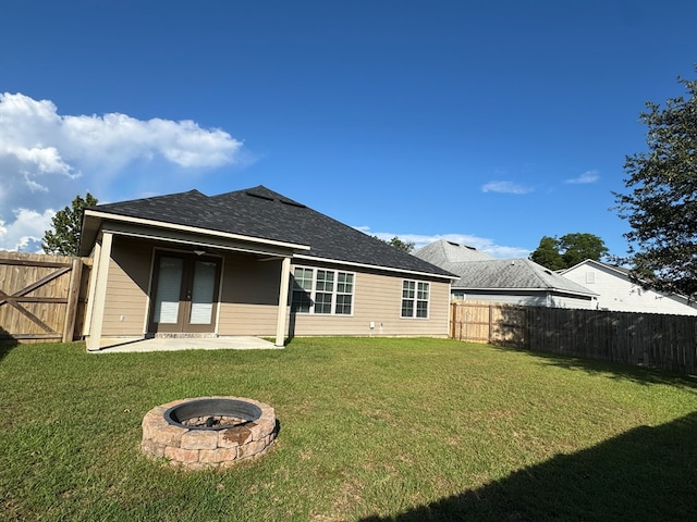564 Osprey Cir, Tifton, GA 31794 - back of property featuring a fenced backyard, a patio area, an outdoor fire pit, and a shingled roof