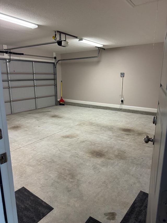564 Osprey Cir, Tifton, GA 31794 - garage featuring a garage door opener and baseboards