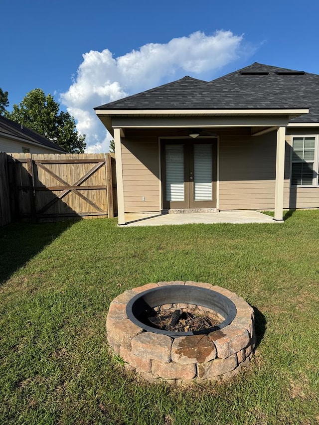 564 Osprey Cir, Tifton, GA 31794 - rear view of property with an outdoor fire pit, a patio, roof with shingles, and french doors