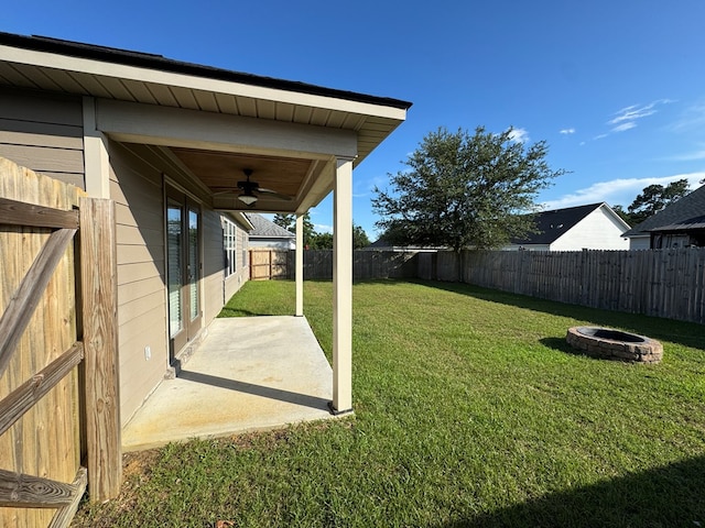 564 Osprey Cir, Tifton, GA 31794 - fenced backyard featuring a fire pit, a ceiling fan, and a patio area