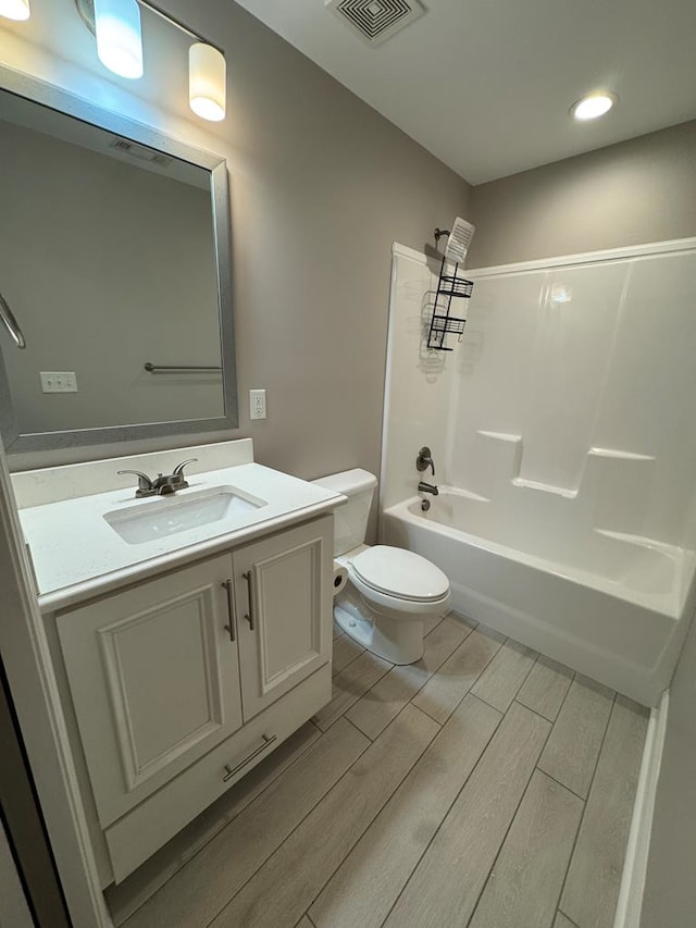 564 Osprey Cir, Tifton, GA 31794 - bathroom featuring vanity, wood finished floors, shower / tub combination, and recessed lighting