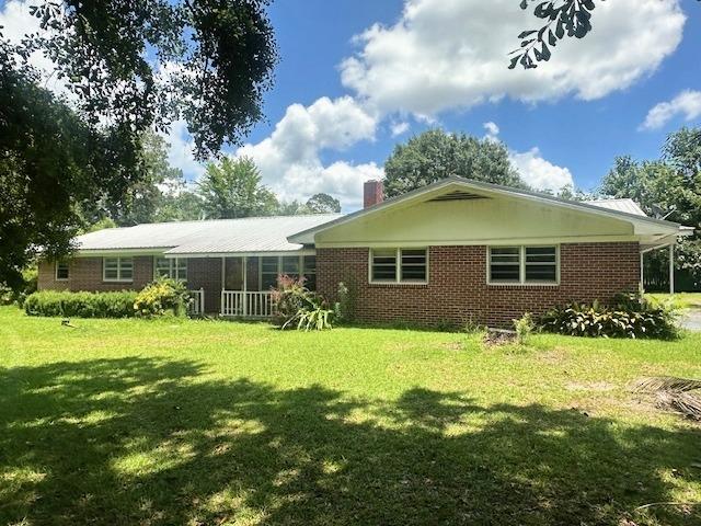 237 Dewey Mcglamry Rd, Fitzgerald, GA 31750 - back of house with a lawn, brick siding, and a chimney