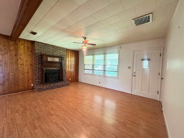 237 Dewey Mcglamry Rd, Fitzgerald, GA 31750 - unfurnished living room featuring wood finished floors, ceiling fan, and a brick fireplace