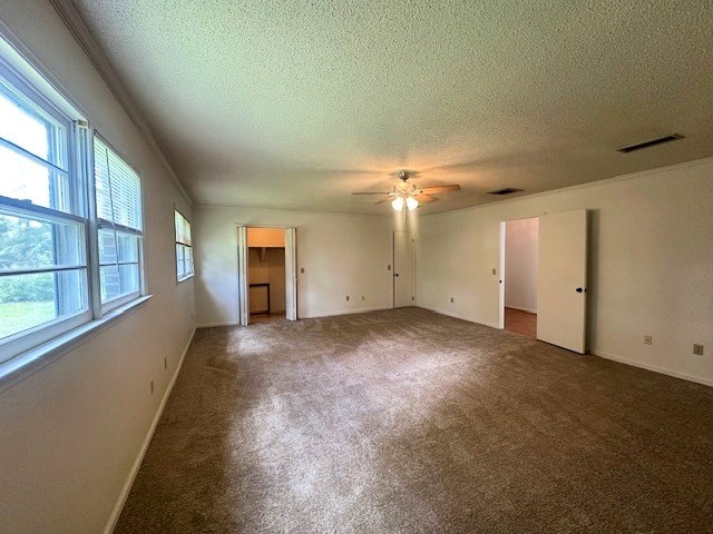 237 Dewey Mcglamry Rd, Fitzgerald, GA 31750 - unfurnished bedroom with a textured ceiling, carpet, and ceiling fan