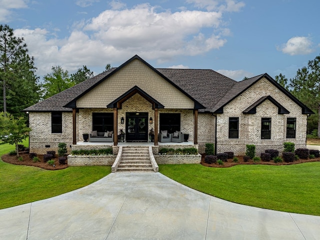 113 N Pointe Dr, Fitzgerald, GA 31750 - view of front of property featuring a front lawn, french doors, brick siding, and a shingled roof