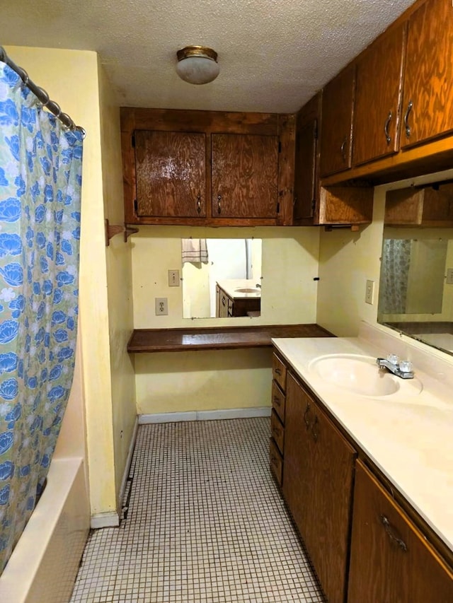 358 Camp Brooklyn Rd, Fitzgerald, GA 31750 - bathroom with vanity, a textured ceiling, baseboards, and shower / tub combo
