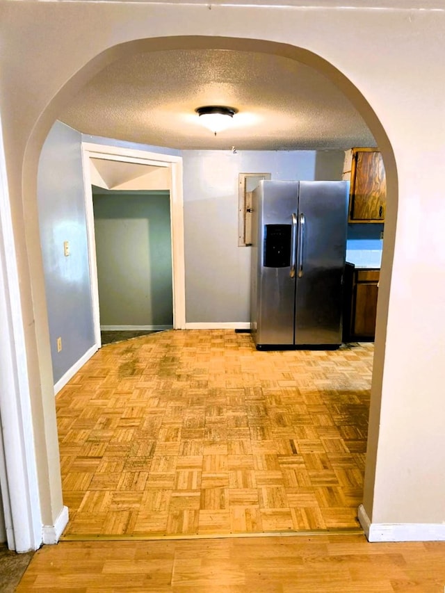 358 Camp Brooklyn Rd, Fitzgerald, GA 31750 - hall featuring arched walkways, baseboards, and a textured ceiling