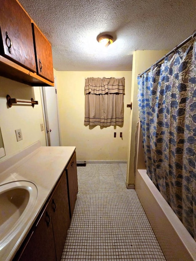358 Camp Brooklyn Rd, Fitzgerald, GA 31750 - full bathroom with vanity, shower / bathtub combination with curtain, a textured ceiling, and baseboards