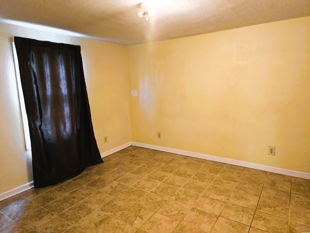358 Camp Brooklyn Rd, Fitzgerald, GA 31750 - empty room featuring a textured ceiling and baseboards