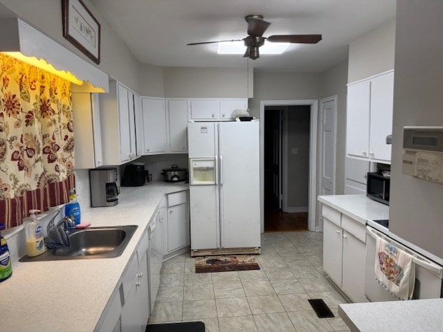 602 20th St, Tifton, GA 31794 - kitchen with a sink, light countertops, ceiling fan, and white appliances