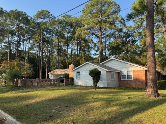 602 20th St, Tifton, GA 31794 - view of home's exterior with a yard, fence, and a chimney