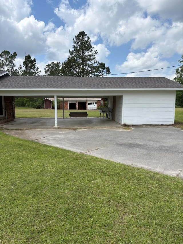 view of car parking with driveway and an attached carport