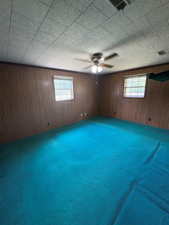 unfurnished room with carpet floors, plenty of natural light, and visible vents
