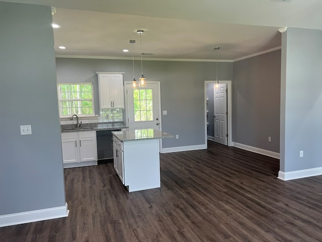 64 Mcintosh Pl, Moultrie, GA 31788 - kitchen featuring dishwasher, baseboards, a kitchen island, crown molding, and white cabinetry