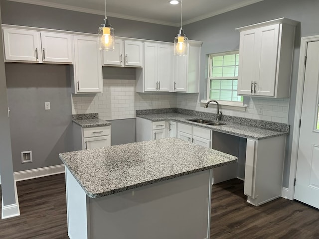 64 Mcintosh Pl, Moultrie, GA 31788 - kitchen with a sink, dark wood-type flooring, light stone counters, crown molding, and recessed lighting