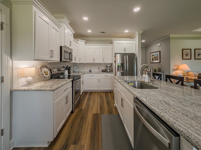 105 Planters Row, Tifton, GA 31793 - kitchen featuring stainless steel appliances, a sink, ornamental molding, dark wood finished floors, and white cabinetry