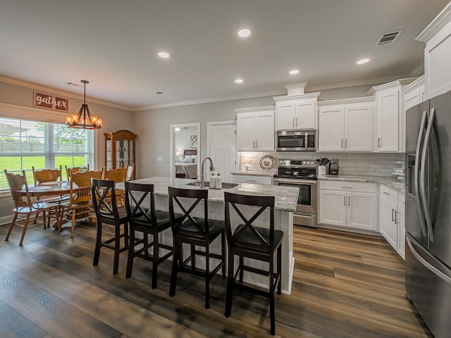 105 Planters Row, Tifton, GA 31793 - kitchen featuring appliances with stainless steel finishes, white cabinets, backsplash, crown molding, and recessed lighting