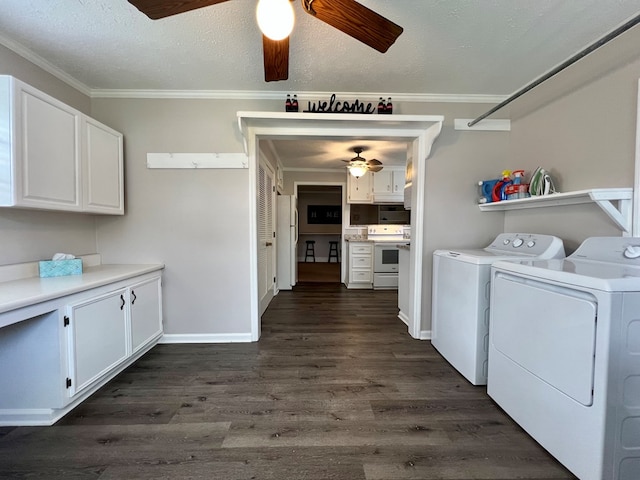 laundry area with a ceiling fan, crown molding, washing machine and dryer, dark wood finished floors, and cabinet space