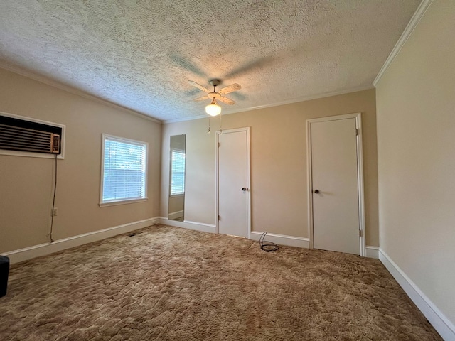 unfurnished bedroom with crown molding, a wall mounted air conditioner, a textured ceiling, and carpet floors