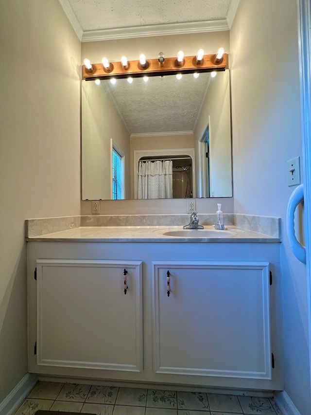 bathroom featuring vanity, ornamental molding, and baseboards