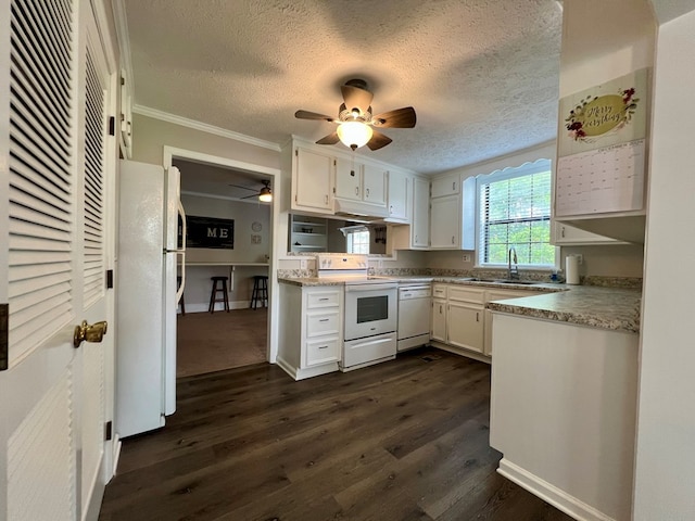 kitchen featuring white cabinets, ceiling fan, a sink, white appliances, and dark wood finished floors