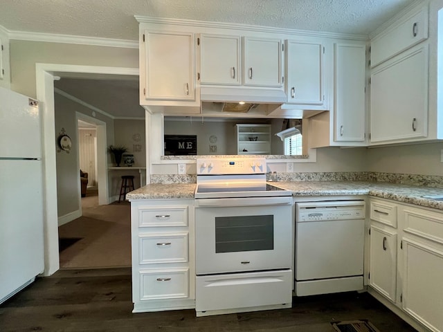 kitchen featuring crown molding, light countertops, dark wood finished floors, and white appliances