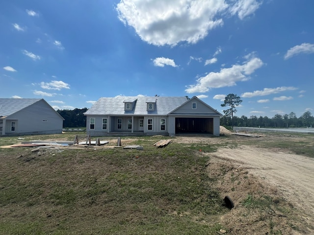 16 Edgewater Ct, Tifton, GA 31793 - rear view of house featuring a lawn, dirt driveway, and an attached garage