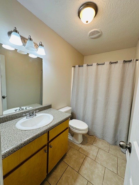 122 Ericas Ct, Fitzgerald, GA 31750 - bathroom featuring vanity, a textured ceiling, tile patterned flooring, and a shower with shower curtain