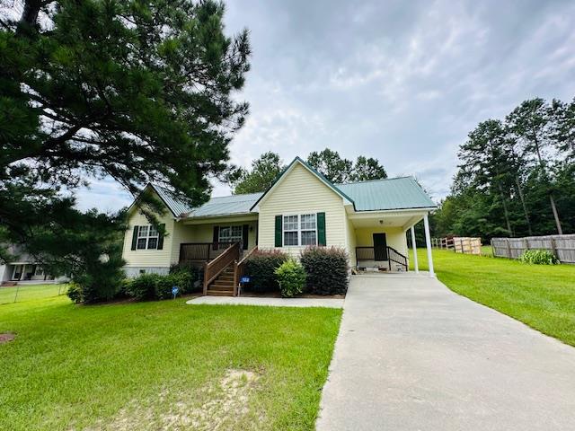122 Ericas Ct, Fitzgerald, GA 31750 - view of front of home featuring concrete driveway, a front yard, a carport, stairway, and covered porch