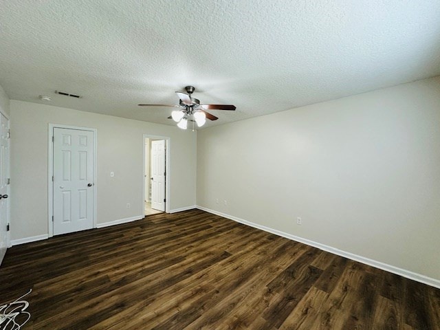 122 Ericas Ct, Fitzgerald, GA 31750 - empty room with dark wood finished floors, ceiling fan, and a textured ceiling