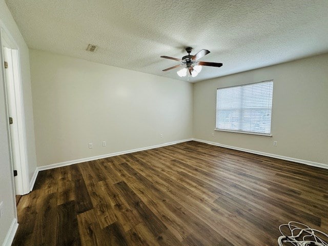 122 Ericas Ct, Fitzgerald, GA 31750 - spare room with dark wood-style floors, a ceiling fan, and a textured ceiling