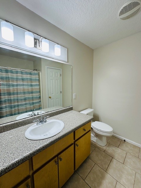 122 Ericas Ct, Fitzgerald, GA 31750 - bathroom with vanity, tile patterned flooring, and a textured ceiling