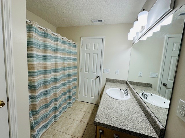 122 Ericas Ct, Fitzgerald, GA 31750 - bathroom with vanity, tile patterned flooring, and a textured ceiling