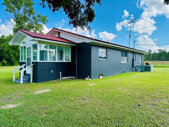 1222 Minton Rd, Sylvester, GA 31791 - view of side of home featuring a lawn, a metal roof, entry steps, and concrete block siding