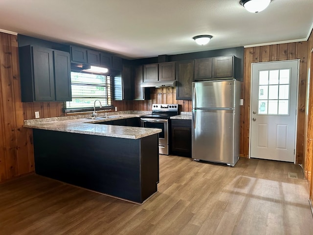 1222 Minton Rd, Sylvester, GA 31791 - kitchen with appliances with stainless steel finishes, under cabinet range hood, a peninsula, light wood-type flooring, and light countertops
