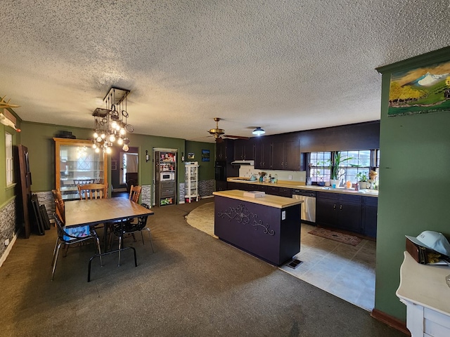 410 W Henderson St, Ocilla, GA 31774 - kitchen featuring a kitchen island, a textured ceiling, a ceiling fan, dishwasher, and decorative light fixtures