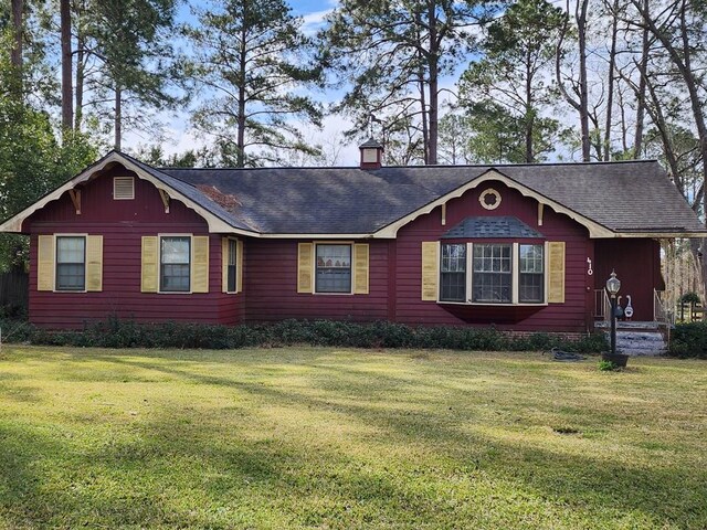 410 W Henderson St, Ocilla, GA 31774 - view of front of home featuring a shingled roof, a front lawn, and a chimney