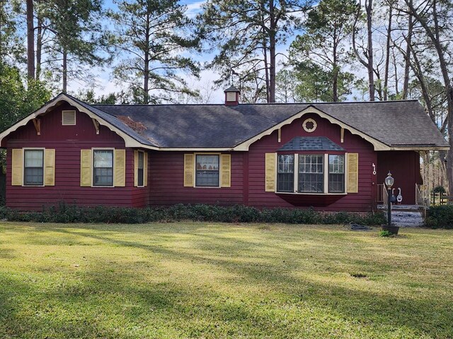 410 W Henderson St, Ocilla, GA 31774 - view of front facade featuring a chimney, a shingled roof, and a front lawn