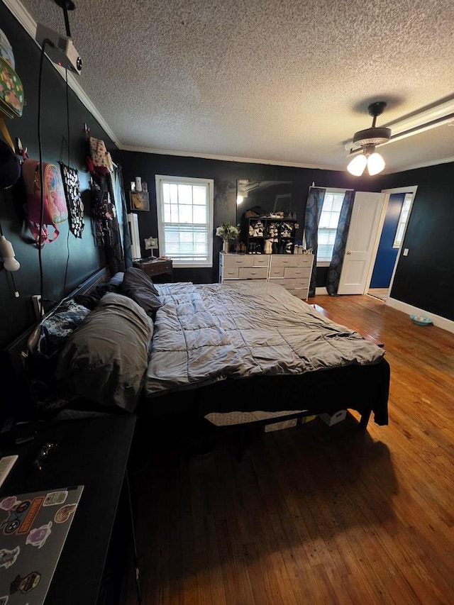 410 W Henderson St, Ocilla, GA 31774 - bedroom featuring crown molding, baseboards, a textured ceiling, and wood finished floors