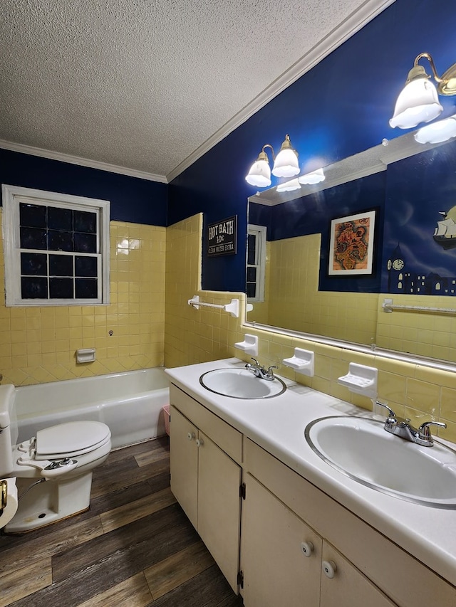 410 W Henderson St, Ocilla, GA 31774 - bathroom with crown molding, a textured ceiling, tile walls, and a sink