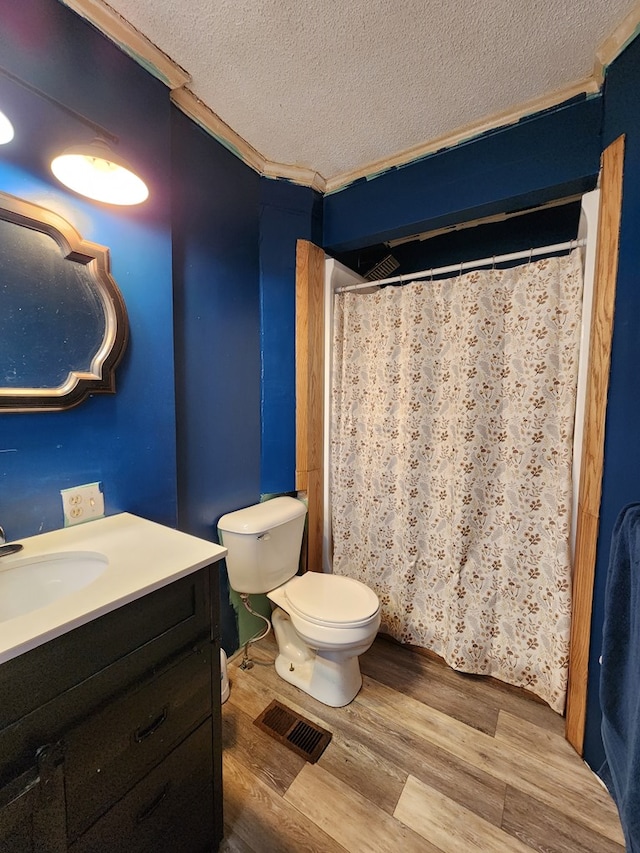 410 W Henderson St, Ocilla, GA 31774 - bathroom featuring a textured ceiling, wood finished floors, vanity, toilet, and ornamental molding
