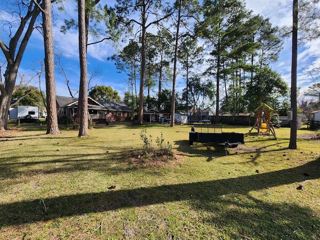 410 W Henderson St, Ocilla, GA 31774 - view of yard with a playground, fence, and a trampoline