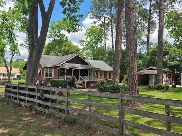 410 W Henderson St, Ocilla, GA 31774 - view of front of property featuring a porch, a front lawn, a fenced front yard, and roof with shingles