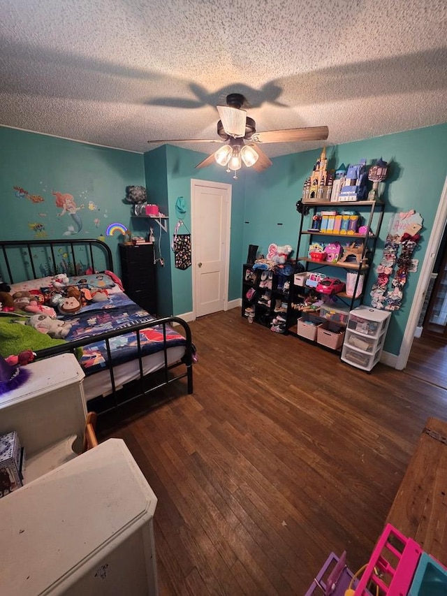 410 W Henderson St, Ocilla, GA 31774 - bedroom featuring baseboards, a ceiling fan, a textured ceiling, and wood finished floors